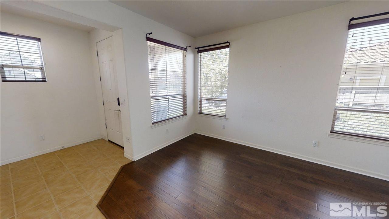 475 Silver Bridle Court Reno, NV 89521 - Photo 3 of 35 an empty room with wooden floor and windows