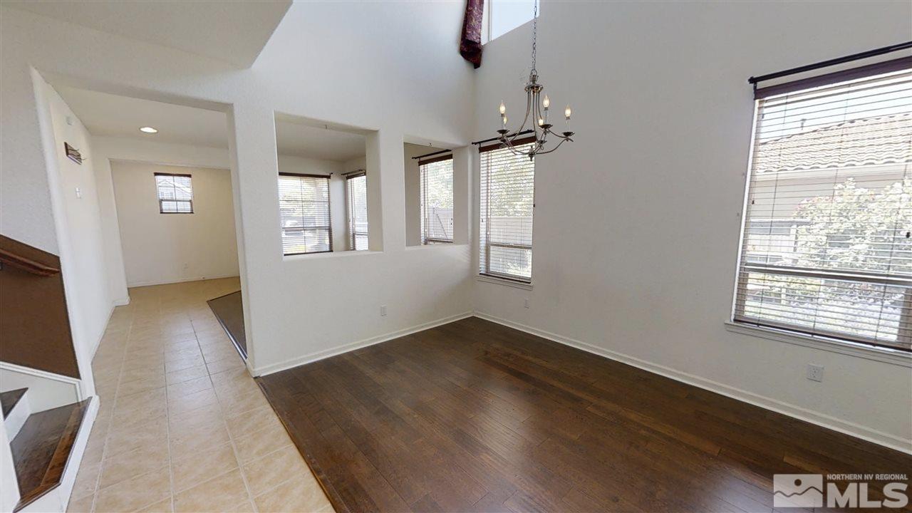 475 Silver Bridle Court Reno, NV 89521 - Photo 5 of 35 an empty room with wooden floor and windows