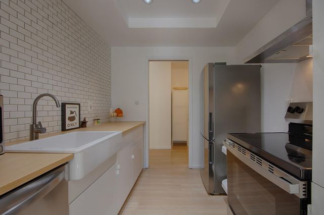 a kitchen with a sink and a stove top oven