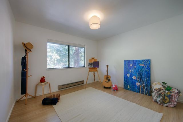 a bedroom with furniture and a window