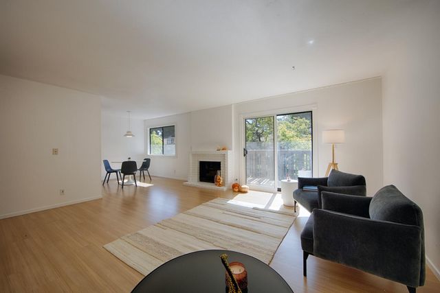 a view of a livingroom with furniture window and wooden floor