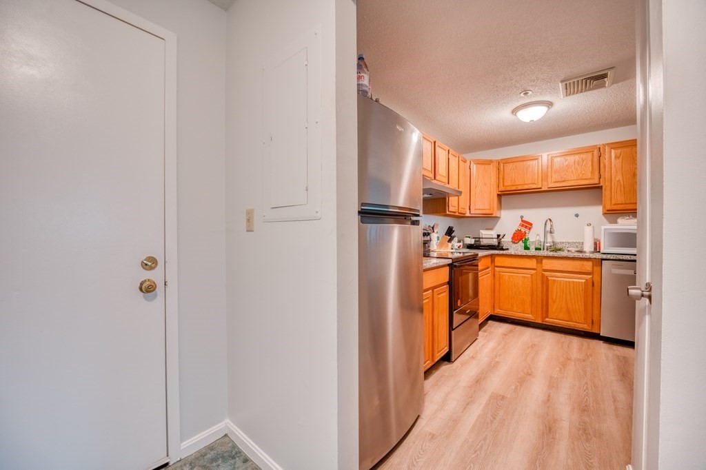 38 Dunham Road, Unit 108 Beverly, MA 01915 - Photo 12 of 30 a kitchen with stainless steel appliances a refrigerator and a sink