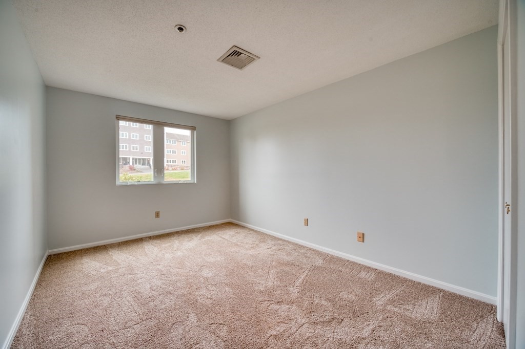 38 Dunham Road, Unit 108 Beverly, MA 01915 - Photo 16 of 30 a view of an empty room with a window