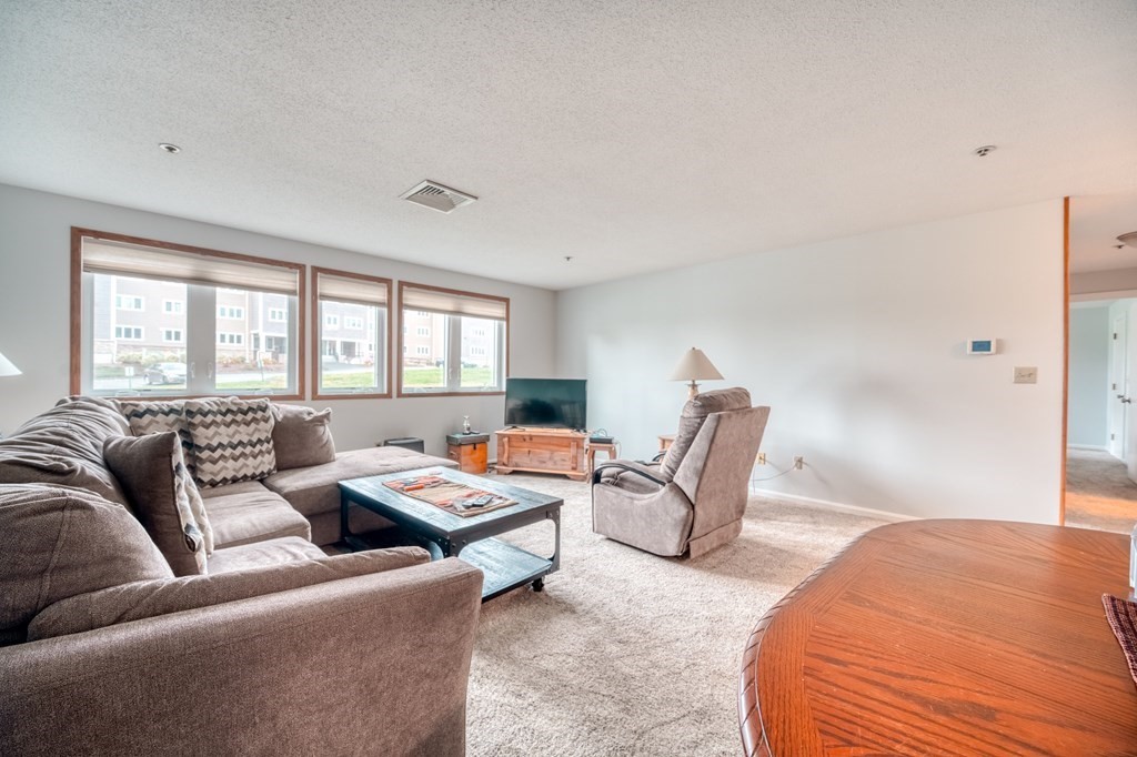 38 Dunham Road, Unit 108 Beverly, MA 01915 - Photo 2 of 30 a bedroom with furniture and a window