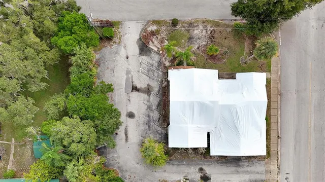 an aerial view of a house with a yard