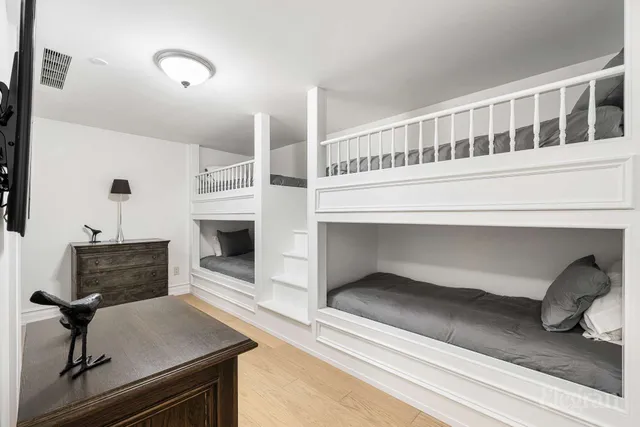 a bathroom with a granite countertop toilet sink and mirror