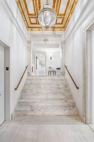 a bedroom with double bed and a flat tv screen on dresser