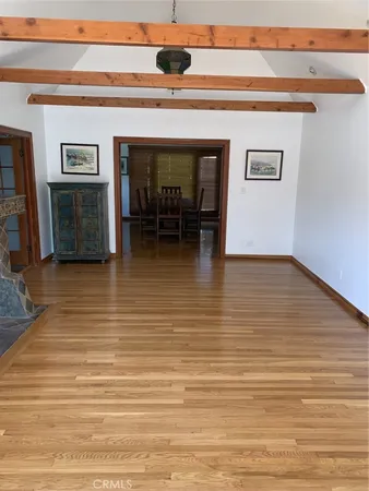 a view of a livingroom with furniture wooden floor and a fireplace