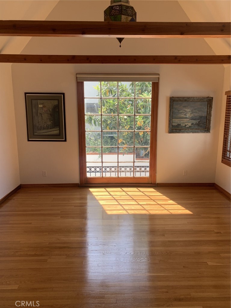 1718 Cleveland Road Glendale, CA 91202 - Photo 12 of 44 a view of an empty room with wooden floor and a window