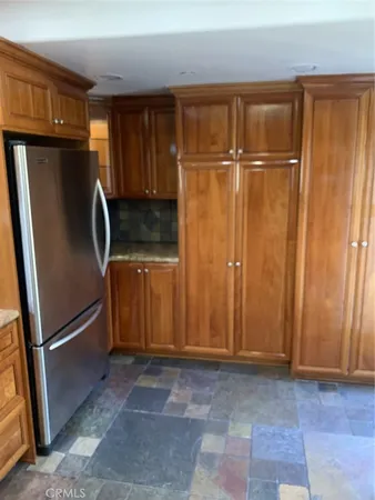 a view of a refrigerator in kitchen