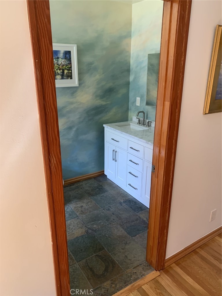 1718 Cleveland Road Glendale, CA 91202 - Photo 24 of 44 a bathroom with a granite countertop sink a mirror a vanity and a shower