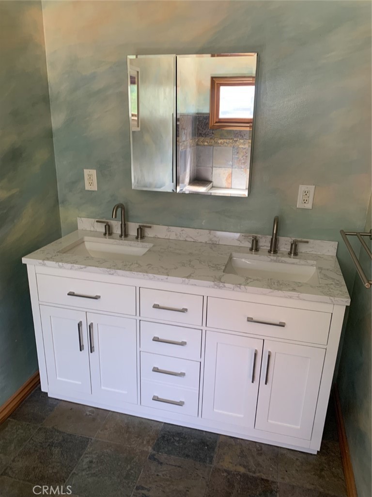 1718 Cleveland Road Glendale, CA 91202 - Photo 25 of 44 a bathroom with a granite countertop sink vanity and a mirror