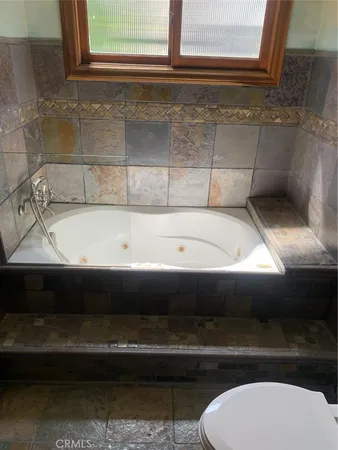 a bathroom with a sink mirror and shower