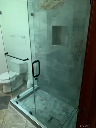 a white toilet sitting next to a bathroom sink