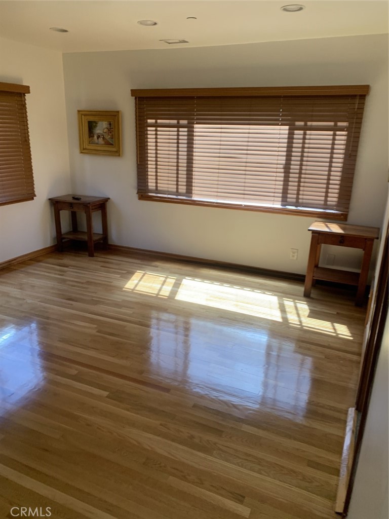 1718 Cleveland Road Glendale, CA 91202 - Photo 36 of 44 a view of an empty room with window and wooden floor