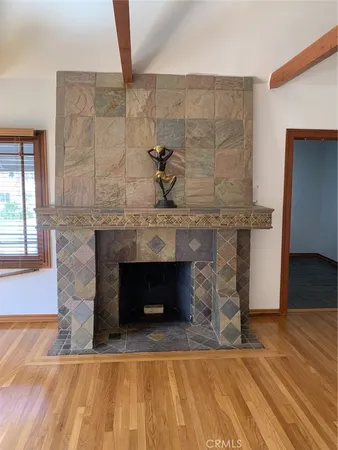 a living room with a fireplace and a wooden floor