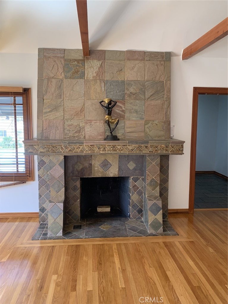 1718 Cleveland Road Glendale, CA 91202 - Photo 10 of 44 a living room with a fireplace and a wooden floor