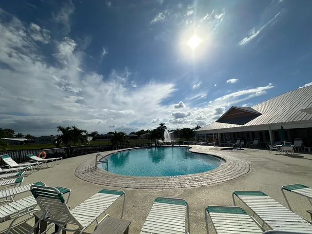 a view of a patio with swimming pool table and chairs
