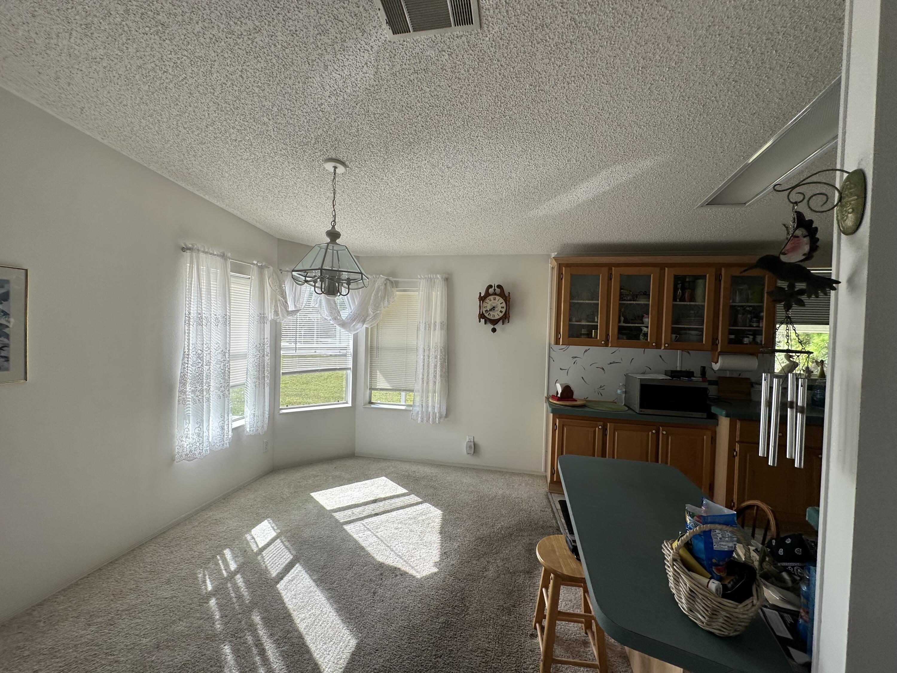302 Tropical Isles Circle Fort Pierce, FL 34982 - Photo 13 of 22 a living room with furniture and a window