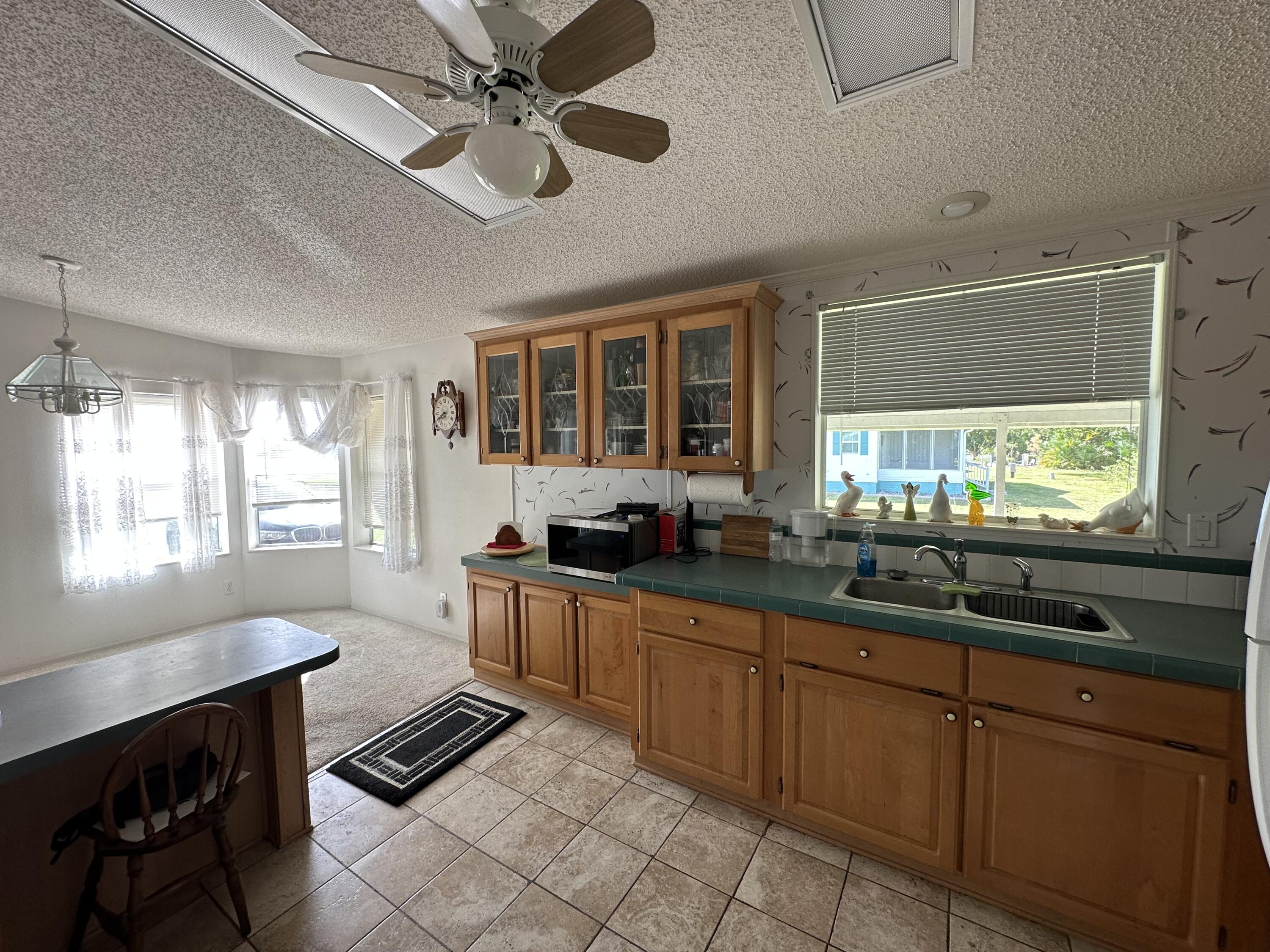 302 Tropical Isles Circle Fort Pierce, FL 34982 - Photo 14 of 22 a kitchen with sink cabinets and window