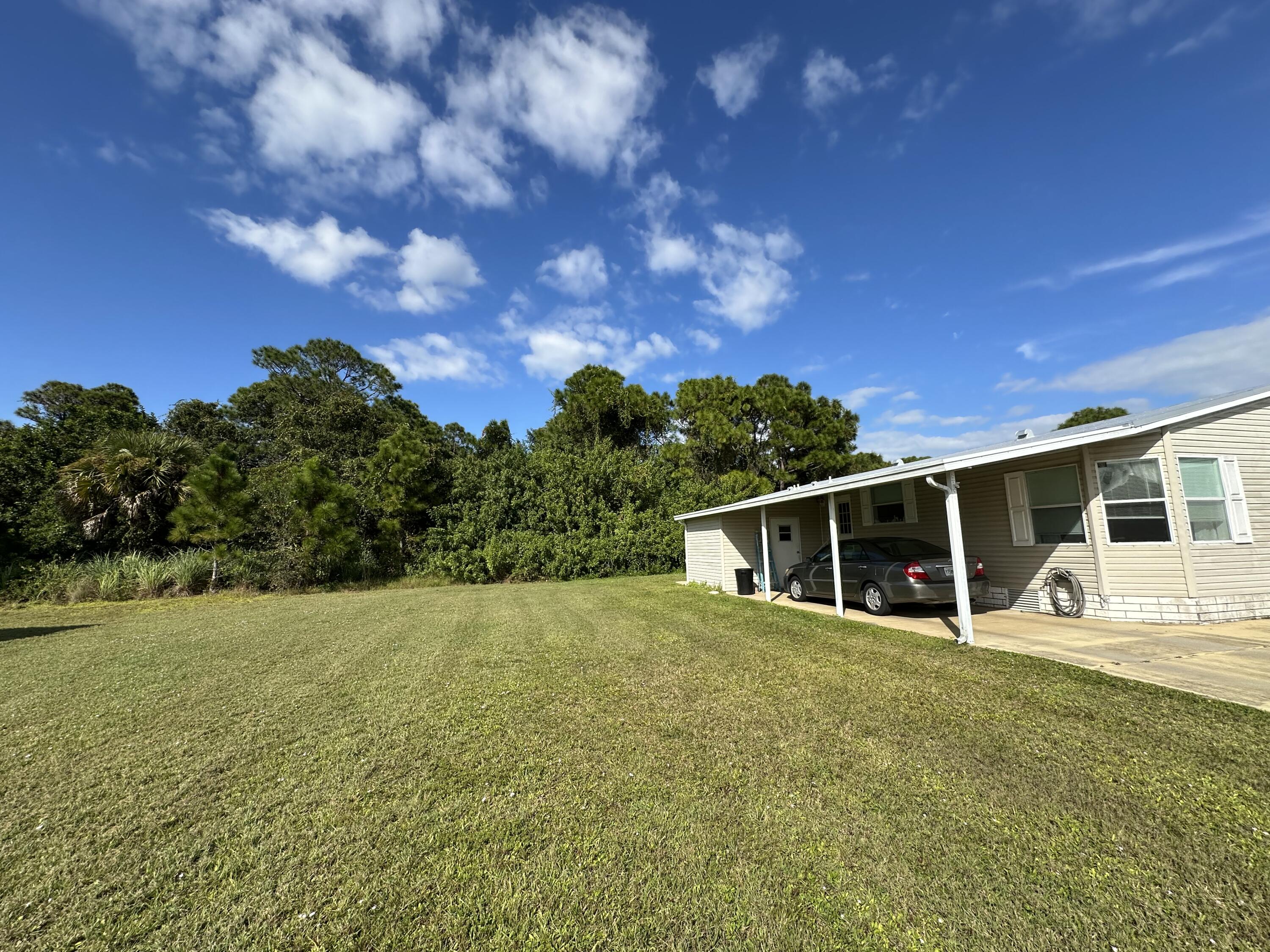 302 Tropical Isles Circle Fort Pierce, FL 34982 - Photo 3 of 22 a view of a house with backyard and sitting area