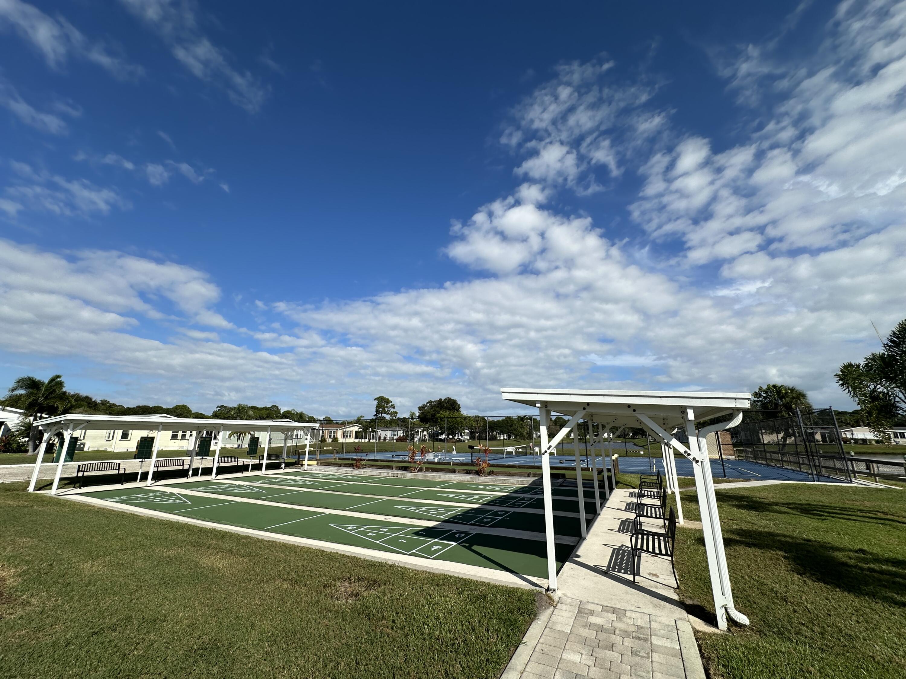 302 Tropical Isles Circle Fort Pierce, FL 34982 - Photo 6 of 22 a view of a big yard with table and chairs