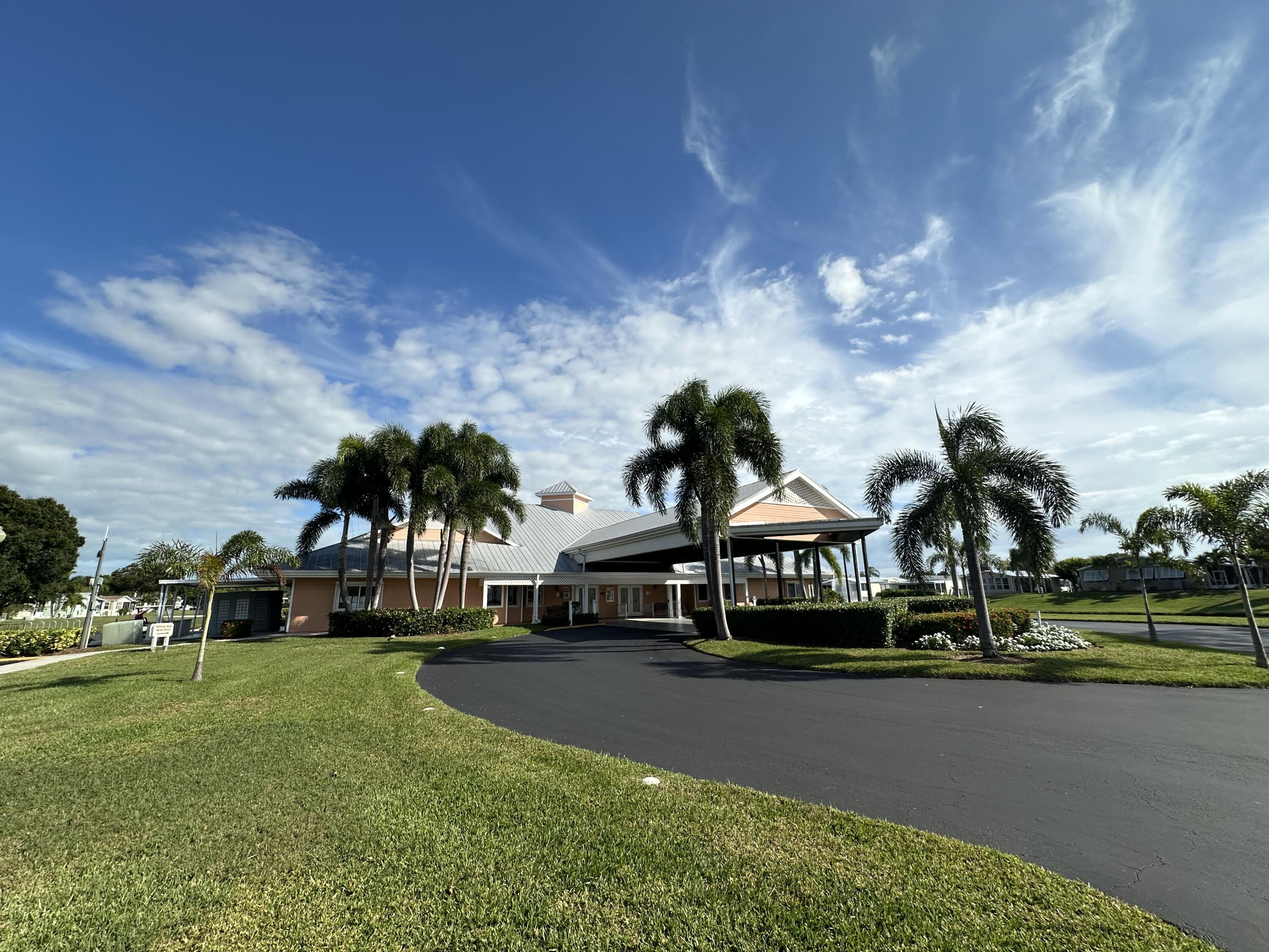 302 Tropical Isles Circle Fort Pierce, FL 34982 - Photo 9 of 22 a front view of a house with garden and houses