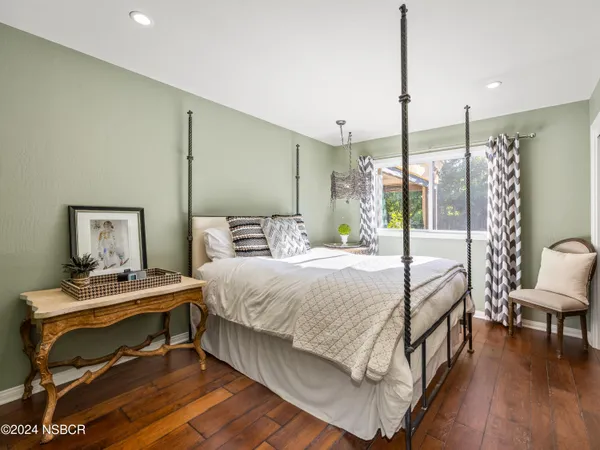 a bedroom with a bed a table and chairs