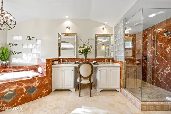 a spacious bathroom with a double vanity sink and a mirror