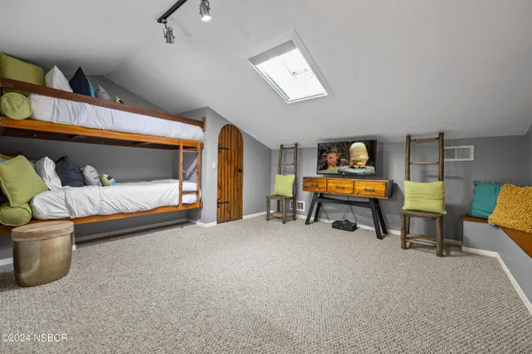 a bedroom with furniture and a lamp