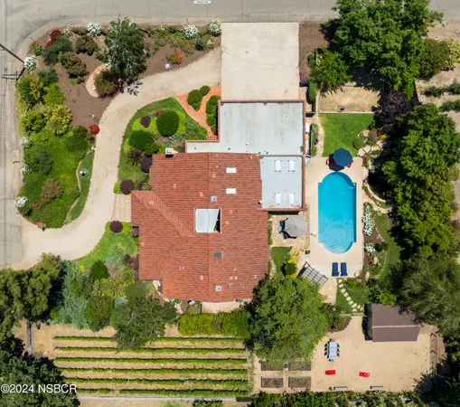 an aerial view of house with yard swimming pool and outdoor seating