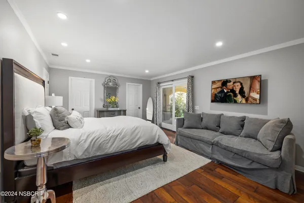 a bedroom with a bed and a couch