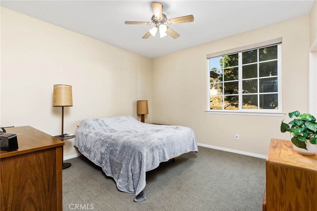 34641 Irwin Street Beaumont, CA 92223 - Photo 11 of 63 a bedroom with a bed and a potted plant