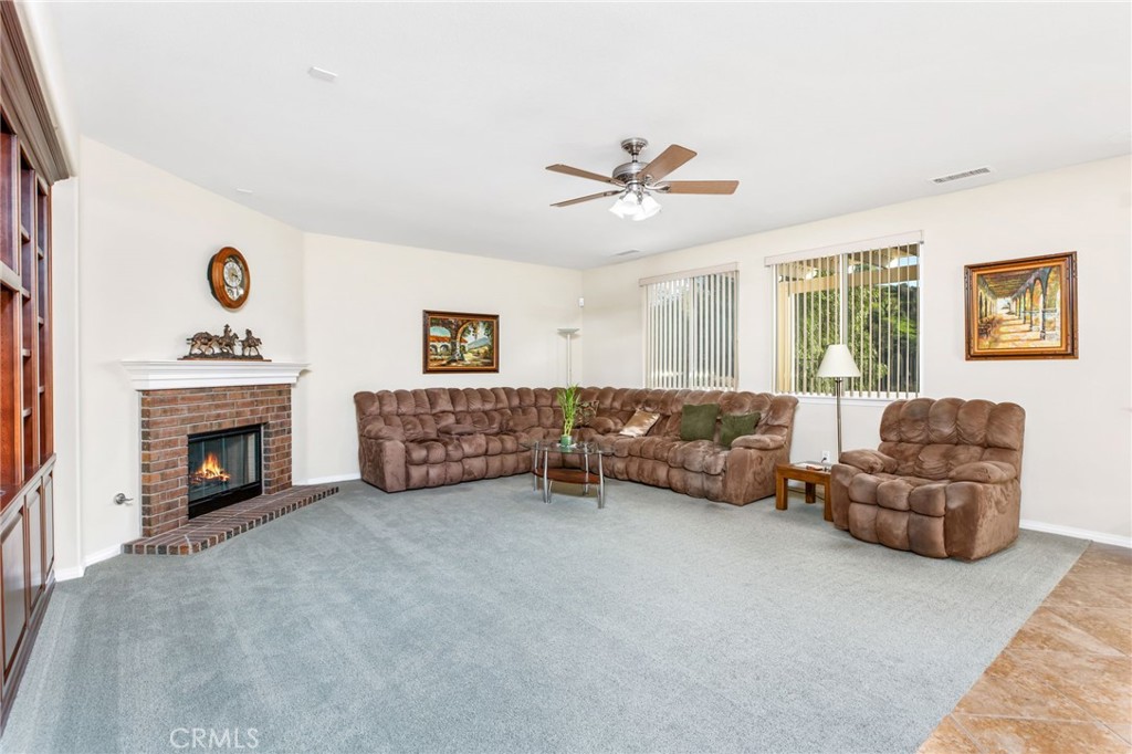 34641 Irwin Street Beaumont, CA 92223 - Photo 14 of 63 a living room with furniture and a fireplace