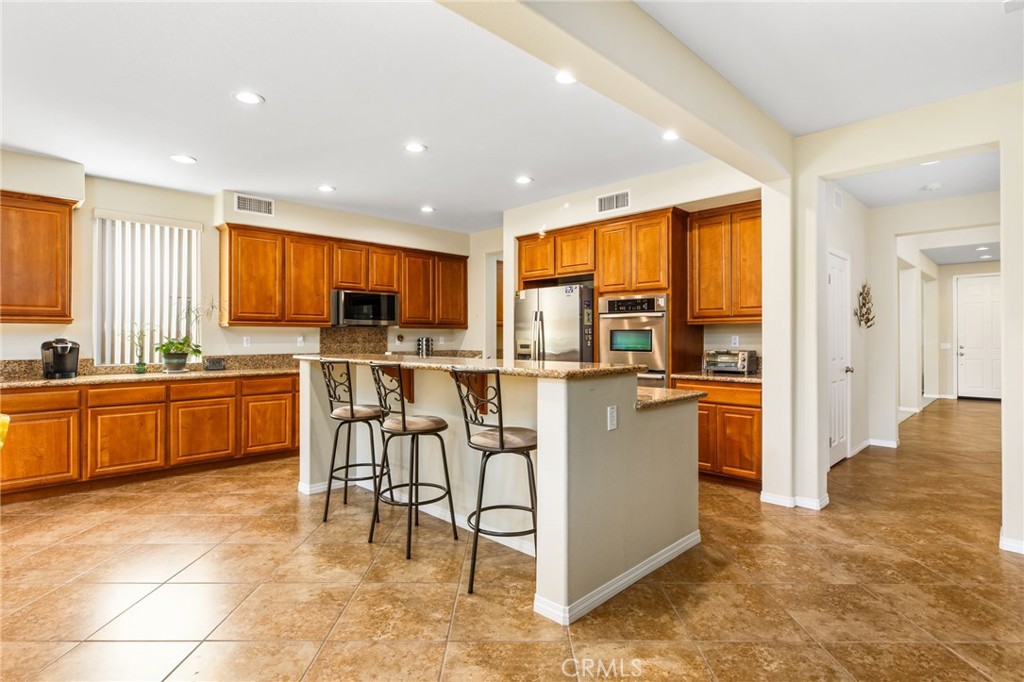 34641 Irwin Street Beaumont, CA 92223 - Photo 17 of 63 a kitchen with a sink a counter top space cabinets and stainless steel appliances
