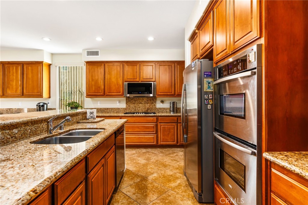 34641 Irwin Street Beaumont, CA 92223 - Photo 18 of 63 a kitchen with stainless steel appliances granite countertop a sink and cabinets