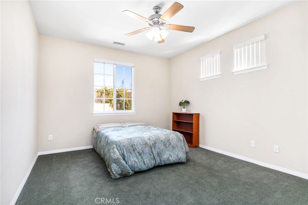 34641 Irwin Street Beaumont, CA 92223 - Photo 27 of 63 a bedroom with a bed and a window