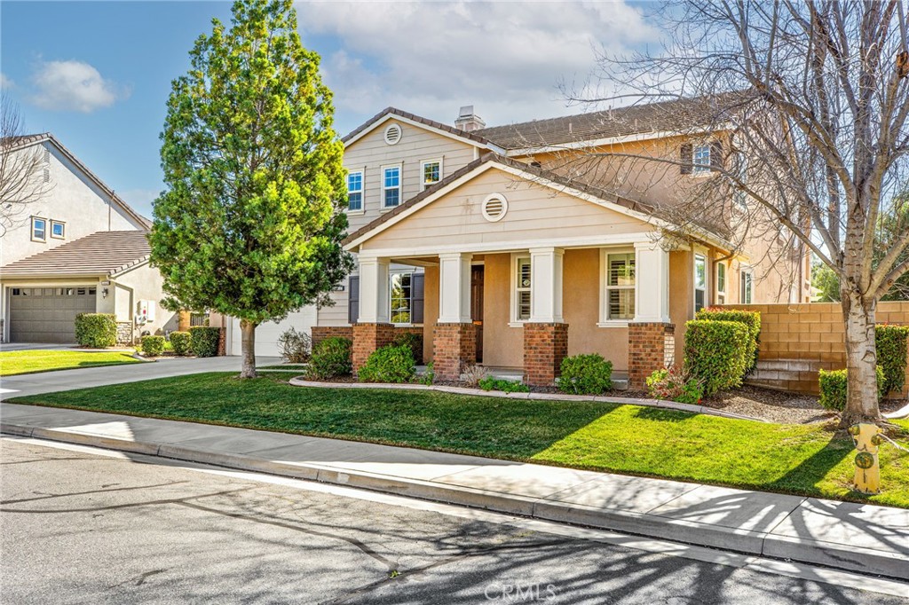 34641 Irwin Street Beaumont, CA 92223 - Photo 3 of 63 a front view of a house with a yard and garage