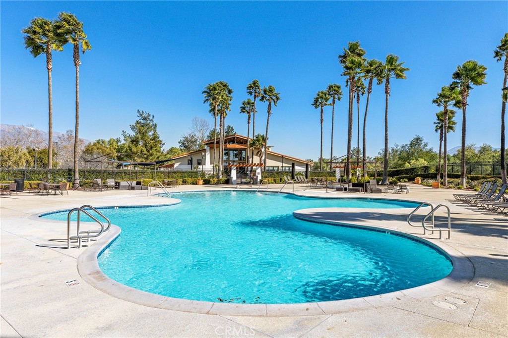 34641 Irwin Street Beaumont, CA 92223 - Photo 57 of 63 a view of a swimming pool with a patio and a lake view