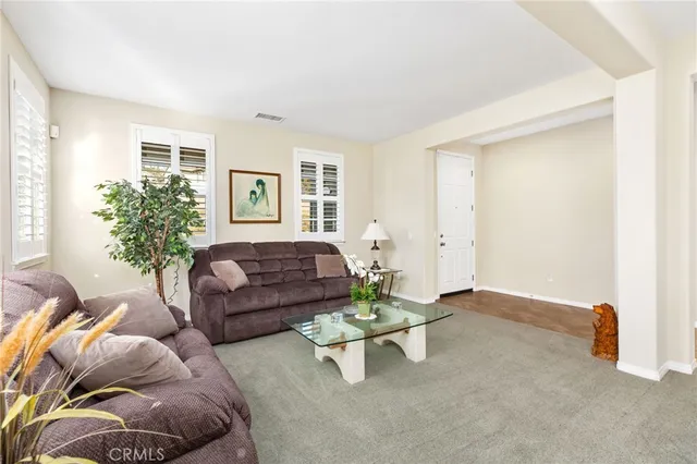 a living room with furniture and flowers