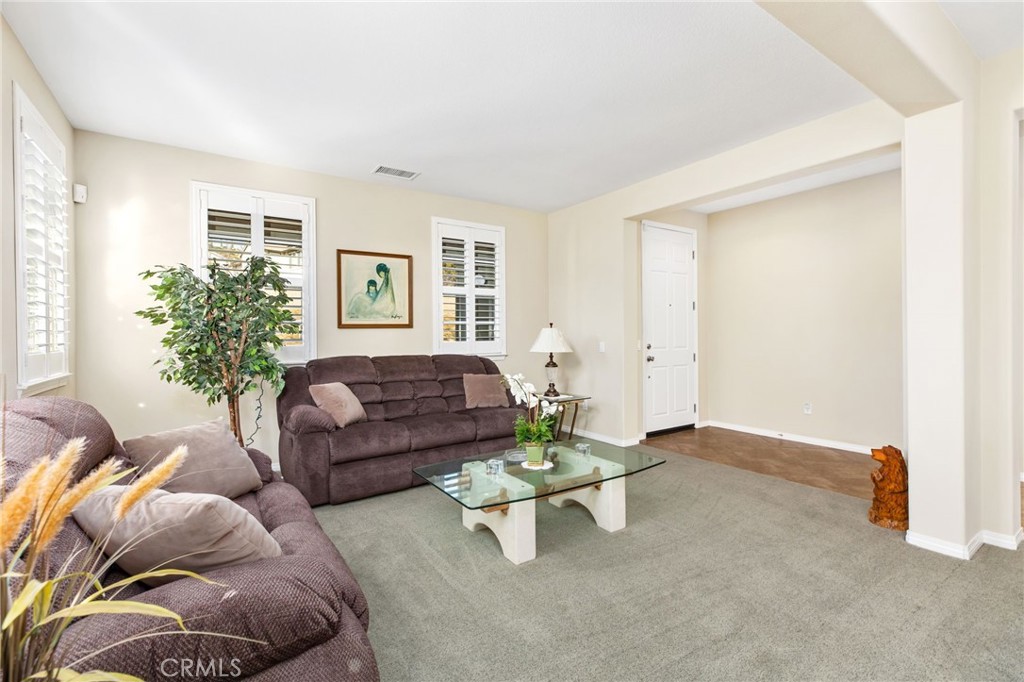 34641 Irwin Street Beaumont, CA 92223 - Photo 7 of 63 a living room with furniture and flowers