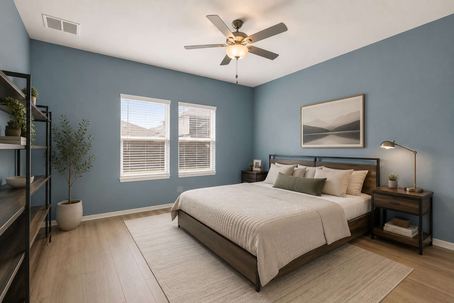 207 Otter Road Kyle, TX 78640 - Photo 9 of 26 Ample natural light highlights the sleek wood flooring and neutral tones of this bedroom.
