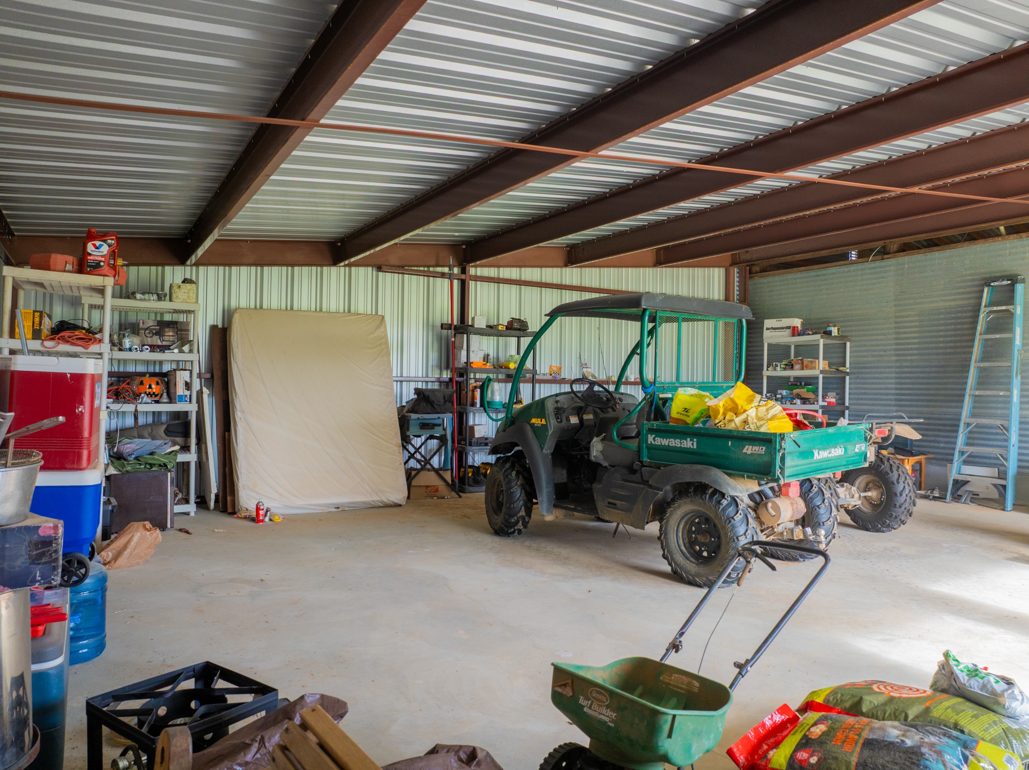 11079 Cr 266 Rochelle Tx 76872 Rochelle, TX 76872 - Photo 24 of 40 Spacious metal-frame covered structure featuring a corrugated metal roof and walls, concrete flooring, and ample storage capacity