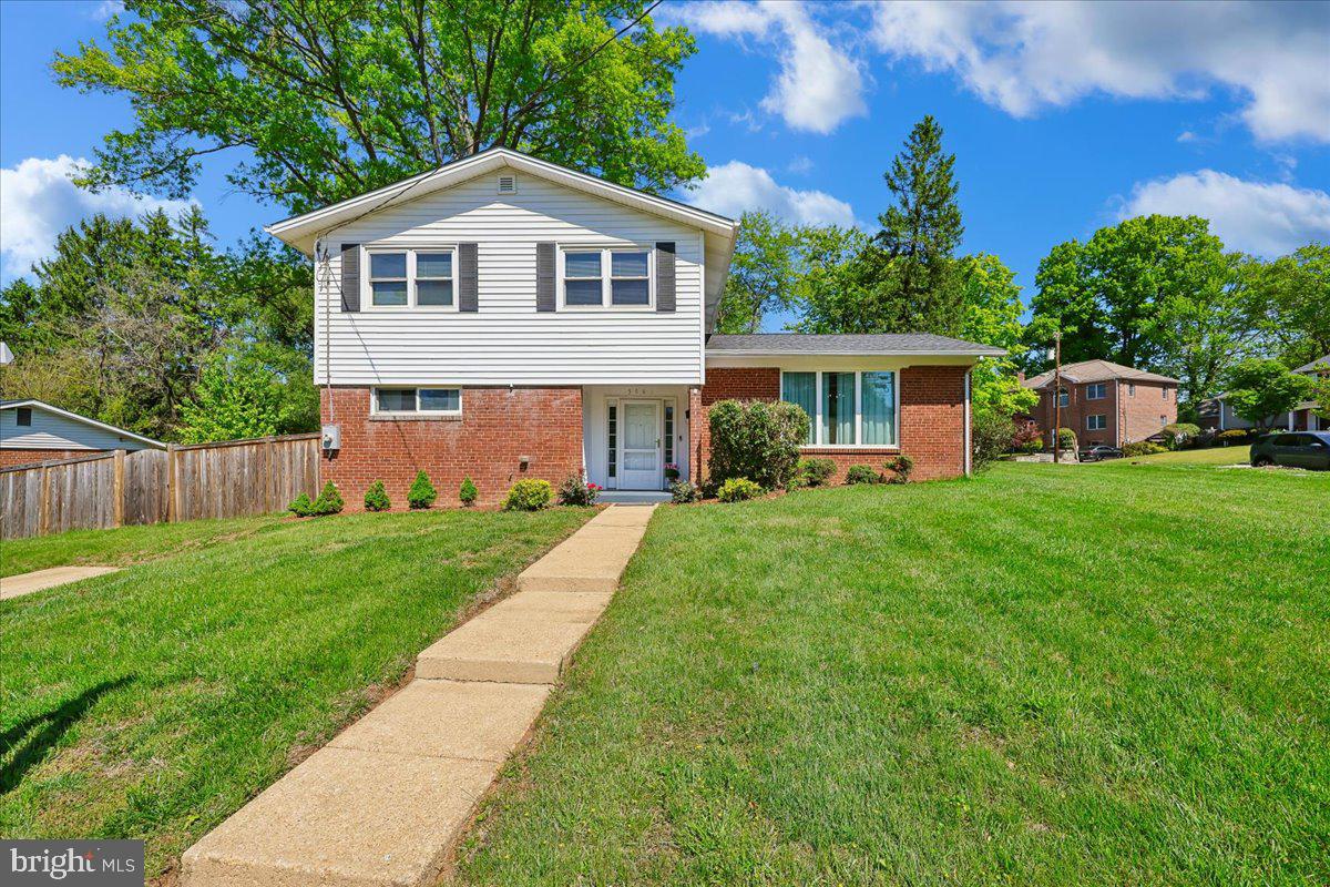 5001 Aspen Hill Road Rockville, MD 20853 - Photo 1 of 68 a front view of a house with garden