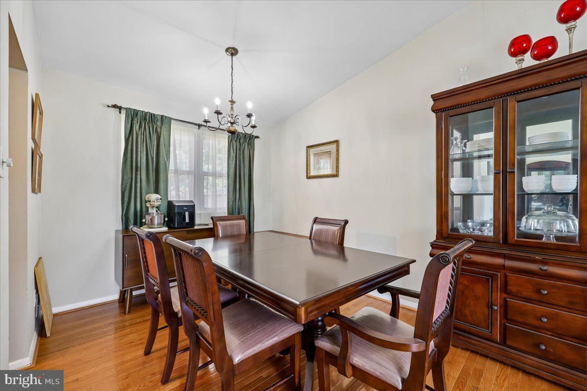 5001 Aspen Hill Road Rockville, MD 20853 - Photo 11 of 68 a view of a dining room with furniture window and wooden floor