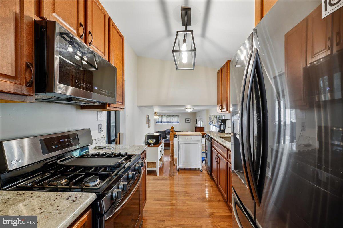 5001 Aspen Hill Road Rockville, MD 20853 - Photo 19 of 68 a kitchen with stainless steel appliances granite countertop a stove top oven a sink and dishwasher