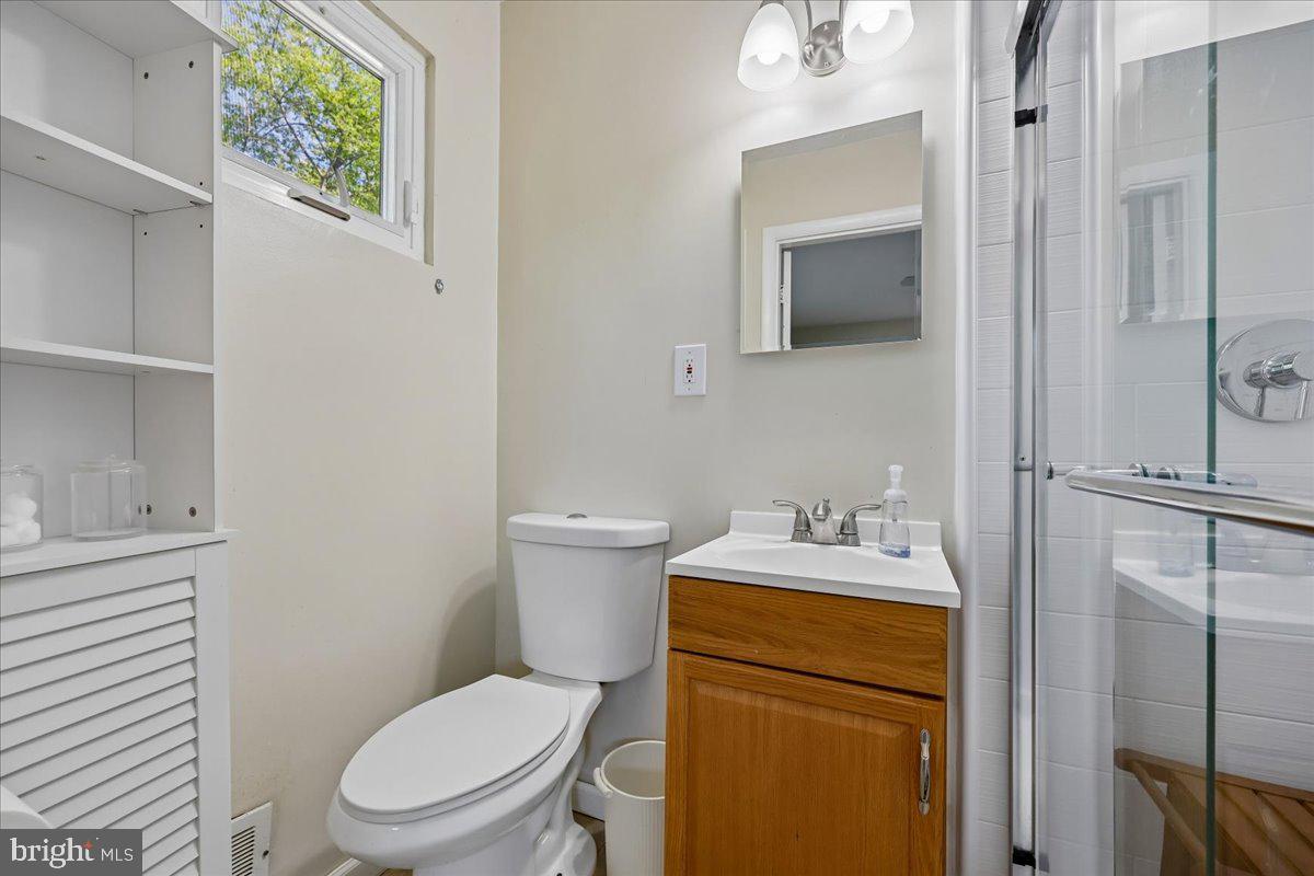 5001 Aspen Hill Road Rockville, MD 20853 - Photo 32 of 68 a bathroom with a toilet sink vanity and mirror