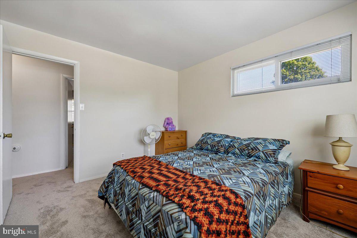 5001 Aspen Hill Road Rockville, MD 20853 - Photo 37 of 68 a bedroom with a bed and a cabinets
