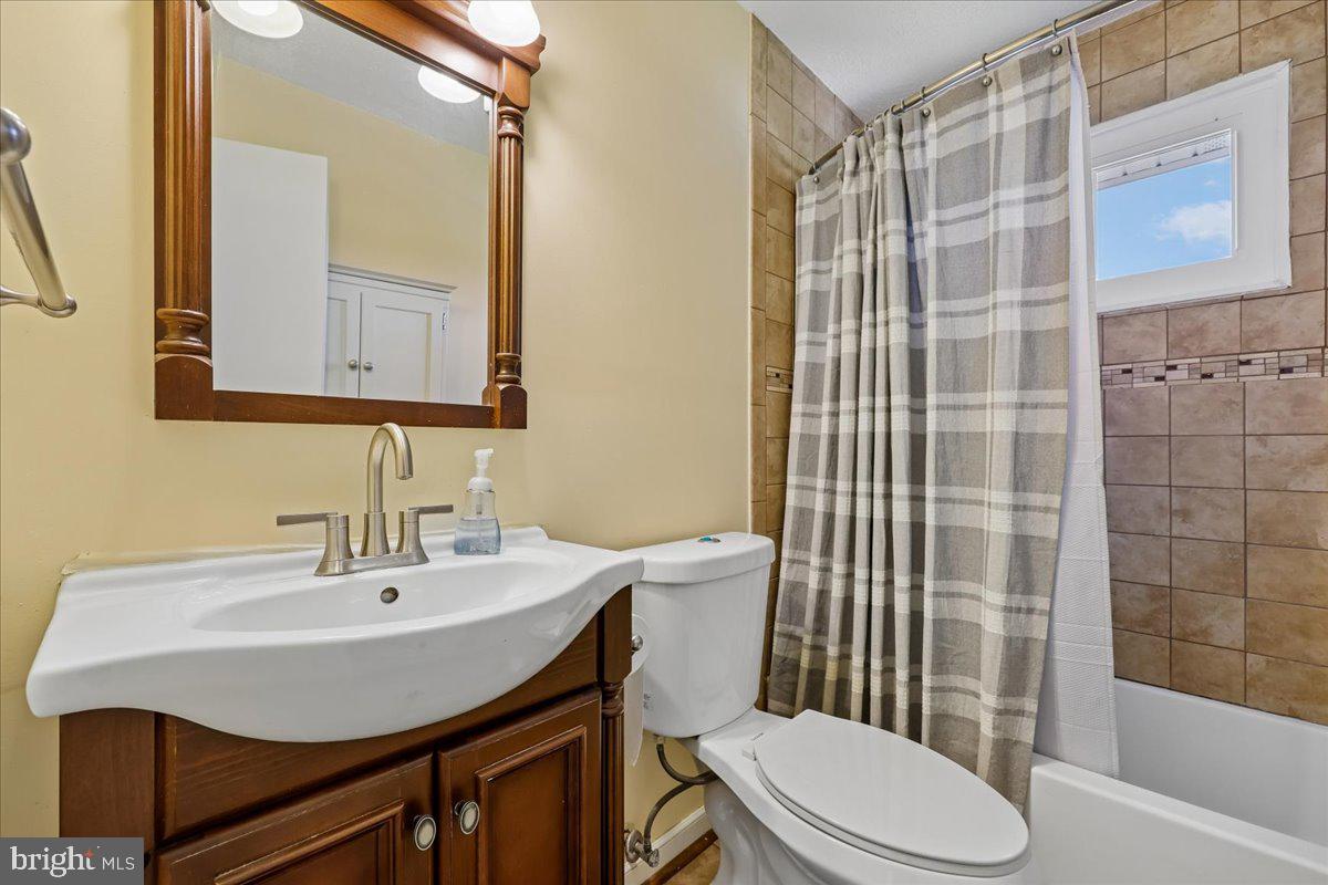 5001 Aspen Hill Road Rockville, MD 20853 - Photo 47 of 68 a bathroom with a sink a toilet and shower
