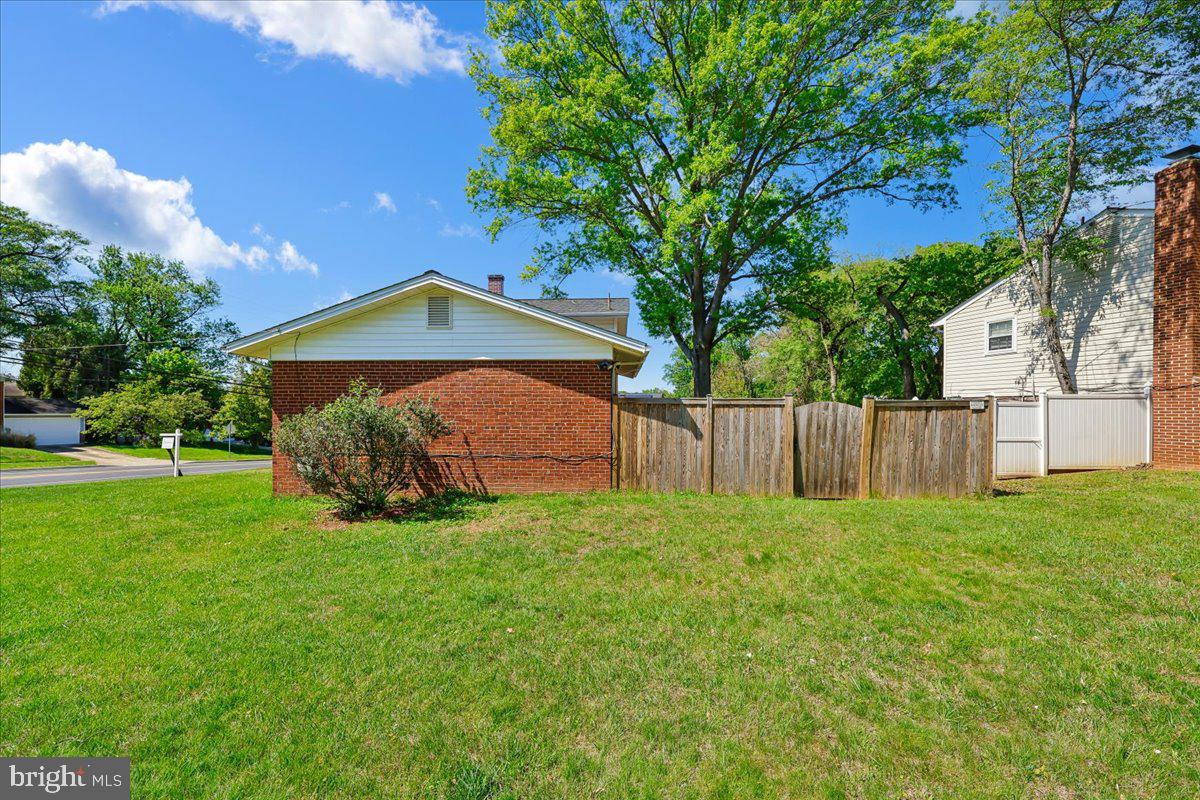 5001 Aspen Hill Road Rockville, MD 20853 - Photo 57 of 68 a view of a house with a yard and a large tree